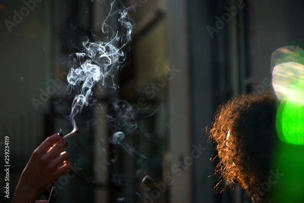 Obraz Minors smoking in a public venue, discussing the regulation of tobacco and other psychedelic substances. Smokers causing second hand smoking. Concept of unhealthy habits and living. Having discussion 