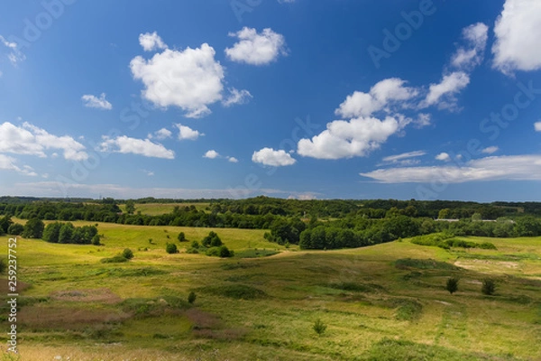 Fototapeta Green hill valley at warm summer day