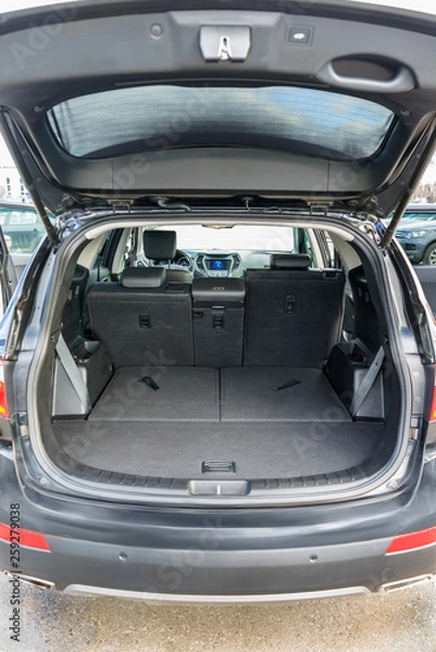 Fototapeta Clean, open empty trunk in the car SUV. Transformation of the seats for carrying luggage in the cabin.