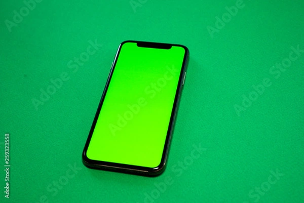 Fototapeta iPhone XS, Phone smartphone, green screen on Green background, top view