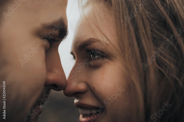 Obraz Young romantic couple is kissing and enjoying the company of each other.