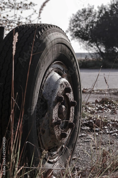 Obraz Abandoned wheel with rubber in the street
