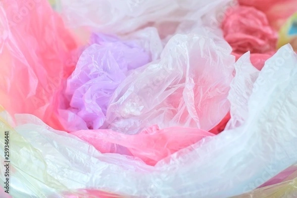 Fototapeta Collection of plastic bags for recycling. Polyethylene bag with selective focus. A pile of plastic bags after shopping.  Ecological problem. Environmental pollution by plastic garbage 
