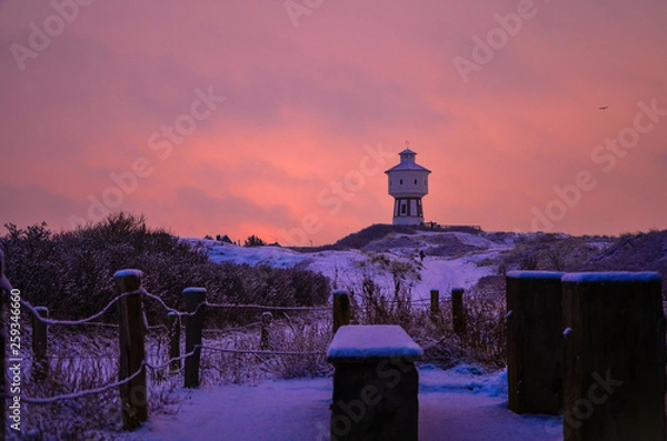 Obraz Sunrise in the city. Lighthouse in the background