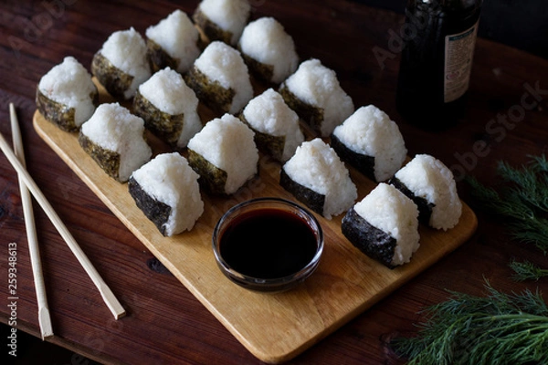 Obraz Onigiri traditional Japanese dish with soy sauce served on the table