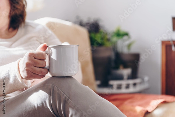 Obraz Close up of elderly woman hands while holding a cup of coffee