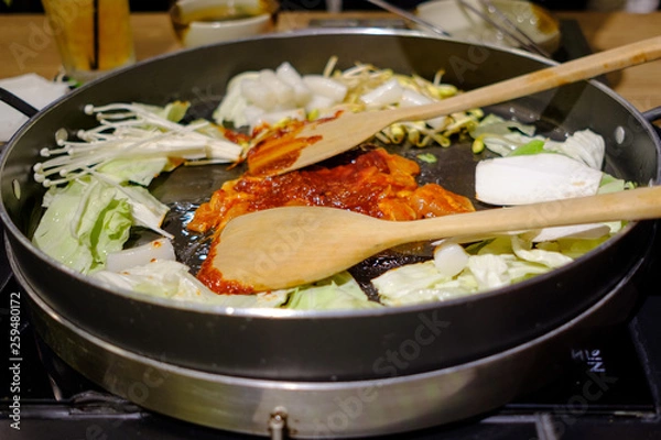 Fototapeta Dakgalbi is Korean famous food Sliced chicken into pieces Mash with ingredients and marinate until When eaten, will be stir-fried with vegetables on a giant pan