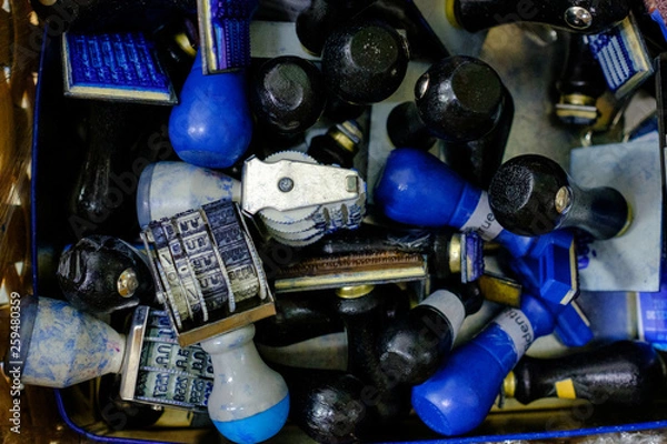 Obraz Many rubber stamps are put together in a basket. Is a Thai rubber stamp and shows the Thai language date and year