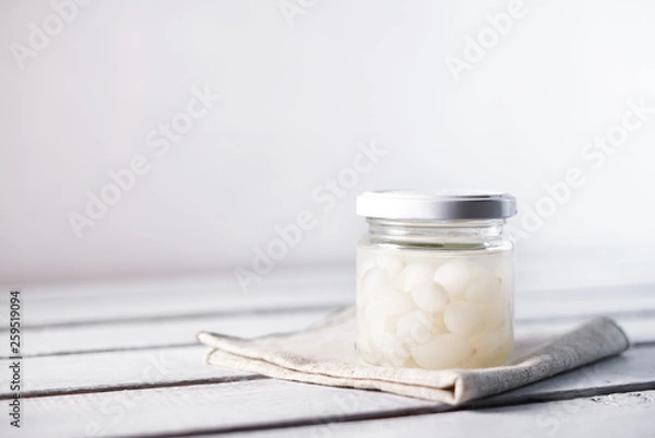 Obraz Glass Jar of Pickled Onions on White wood Background