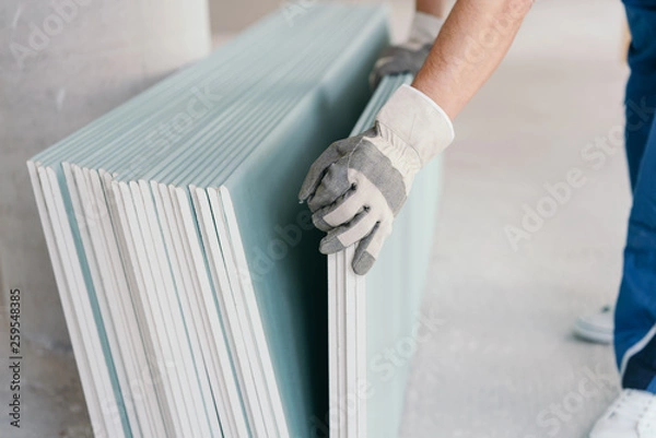Obraz Builder taking a sheet of chip board cladding