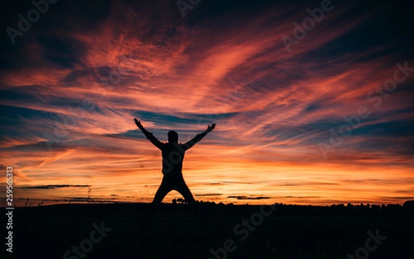 Fototapeta Man jumping in the beautiful sunset