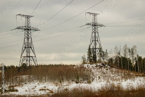 Fototapeta Spring, in some places there is snow, the railway bridge over the river, the village. 