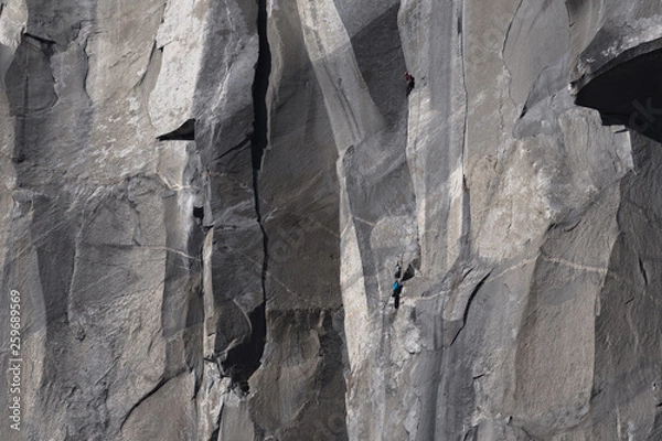 Obraz Climbers attempt to climb jagged granite of El Capitan in Yosemite National Park