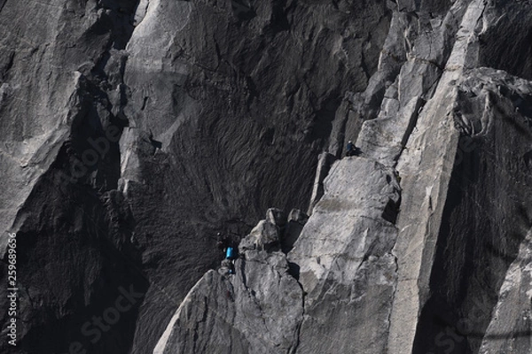 Obraz Climbers attempt to climb jagged granite of El Capitan in Yosemite National Park