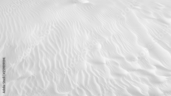 Fototapeta White sand texture background with wave pattern and insect trails	