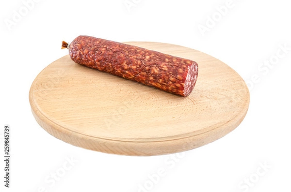Fototapeta smoked sausage on a wooden board and on a white background