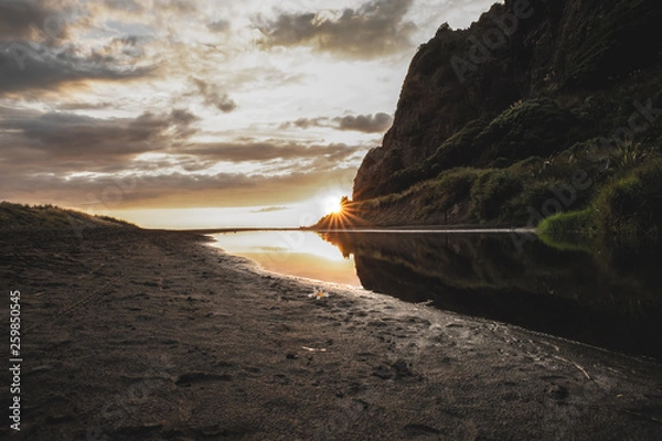 Fototapeta Beach sunset by cliffside