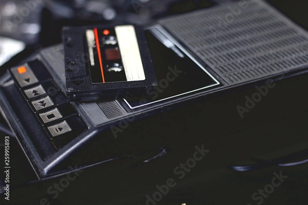 Fototapeta Old retro vintage black portable audio cassette player and recorder with audio tape on top 70s, 80s, 90s style