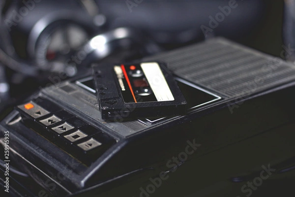 Fototapeta Old retro vintage black portable audio cassette player and recorder with audio tape on top 70s, 80s, 90s style