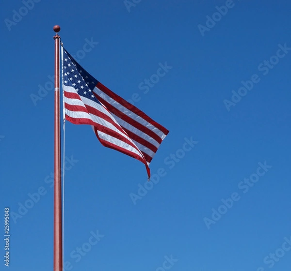 Obraz U.S. Flag against a clear blue sky