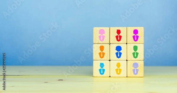 Fototapeta Building a good and strong team, recruitment business and human resources concept, wooden blocks with people icon on table, blue background, copy space