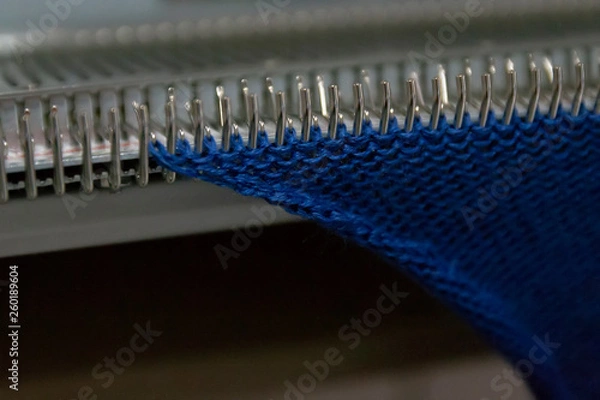 Fototapeta Manual knitting machine. A knitting machine is a device used to create knitted fabrics
