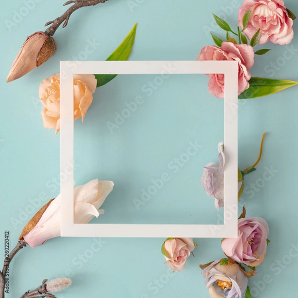 Fototapeta Easter composition made with flowers and eggs on bright blue background with ribbon copy space. Creative minimal holiday concept. Flat lay.