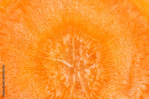 Fototapeta Fresh carrot in a cut close-up. Bright orange photography is suitable as a background for the themes of vegetarianism, healthy eating, veganism.