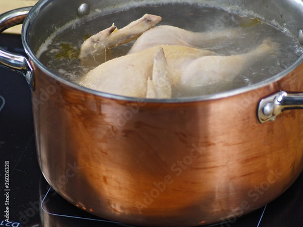 Fototapeta whole chicken in a soup pot