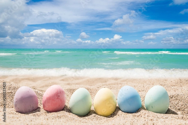 Obraz Happy easter lettering background with eggs on the sandy beach