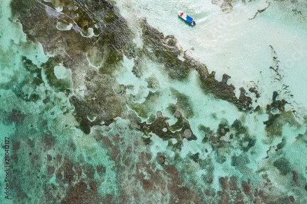 Fototapeta Aerial view on caribbean sea with floating boat
