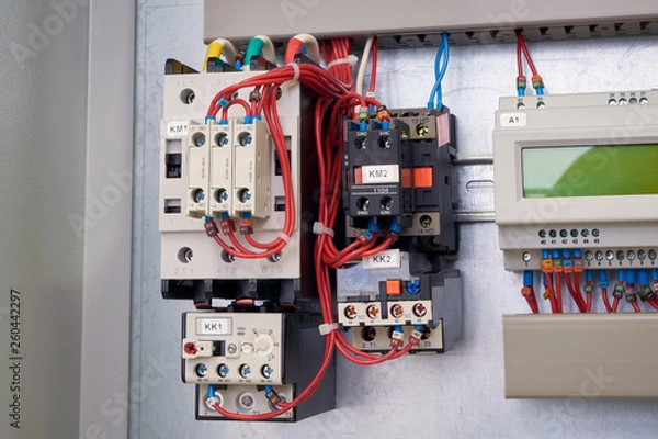 Fototapeta Starting Assembly of contactors and thermal relays in the electrical Cabinet. Right controller for remote control and programming with LCD display. Pump or motor control Cabinet.