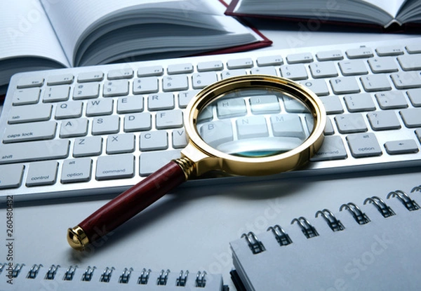 Obraz magnifying glass on the pc keyboard search technology concept