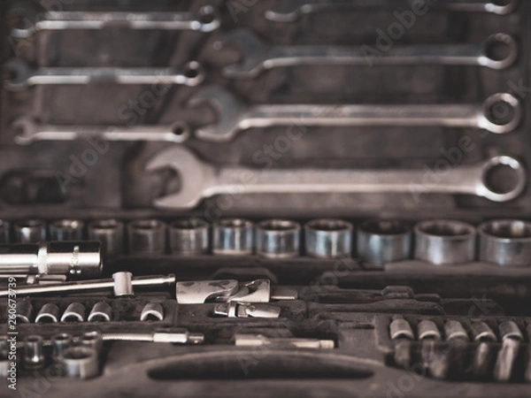 Fototapeta Workspace in garage; different tools and equipment for home repairing; toolbox for builder, repairman, handyman with used toolkit; renovation workshop; working area for leisure time and service