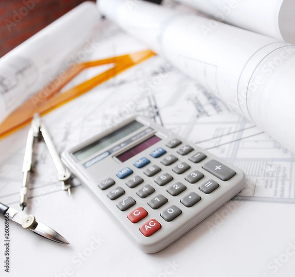 Obraz Calculator and drafting tools on architectural desk