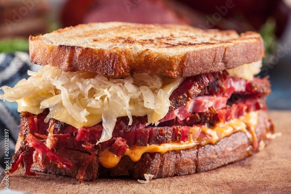 Fototapeta Reuben Sandwich with corned beef, cheese and sauerkraut