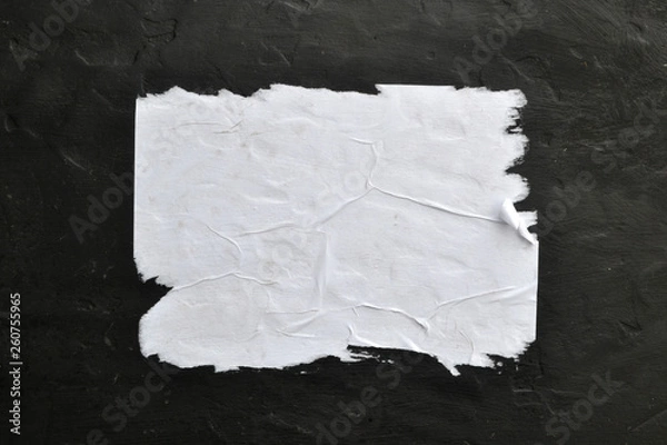 Obraz Biała kartka papieru na czarnym tle.
