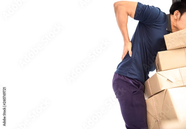 Obraz Worker courier male mover holding package parcels boxes with backache while lifting brown card boxes isolated on white background .Delivery concept