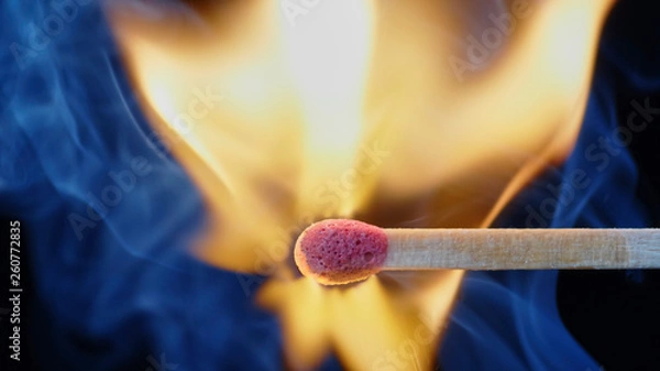 Fototapeta Macro shot of a wooden matchstick igniting in a millisecond of a small but powerful explosion.