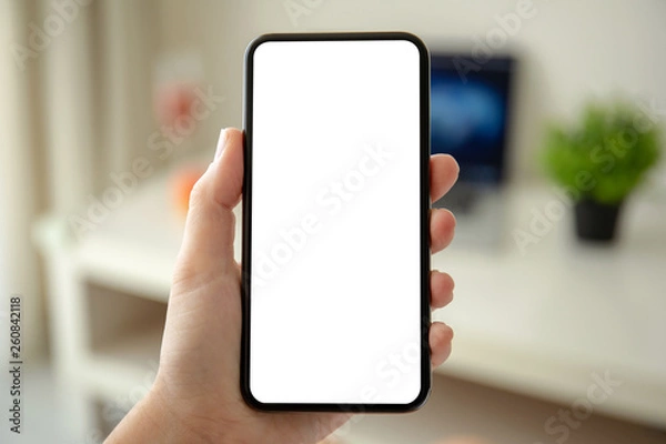 Fototapeta female hands holding phone with isolated screen in the room