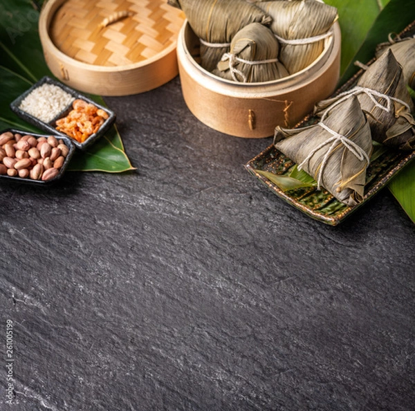 Fototapeta Close up, copy space, top view, famous asian chinese tasty handmade food in dragon boat(duan wu) festival, steamed rice dumplings shaped pyramidal by leaves ingredients