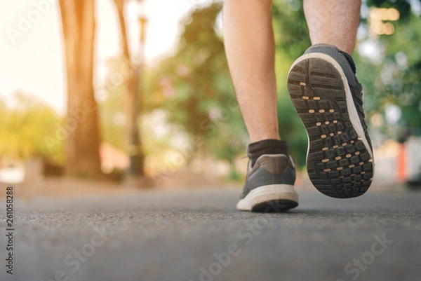 Fototapeta Man running on the park with Close up shoes 