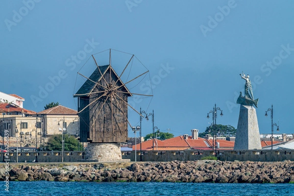 Fototapeta The wooden windmill on the isthmus Nessebar ancient city, one of the major seaside resorts on the Bulgarian Black Sea Coast. Nesebar or Nesebr is a UNESCO World Heritage Site. The windmill in Nessebar