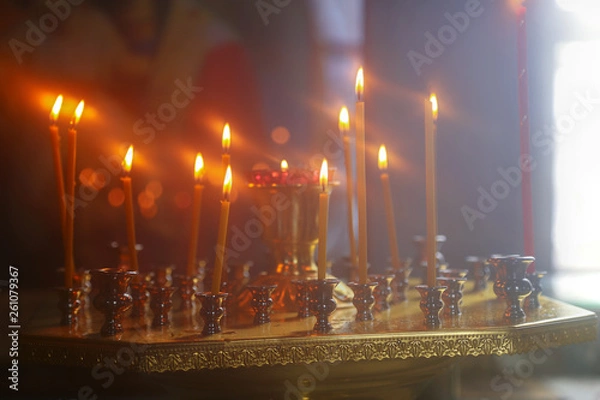 Obraz Burning candles in front of the altar in the church.