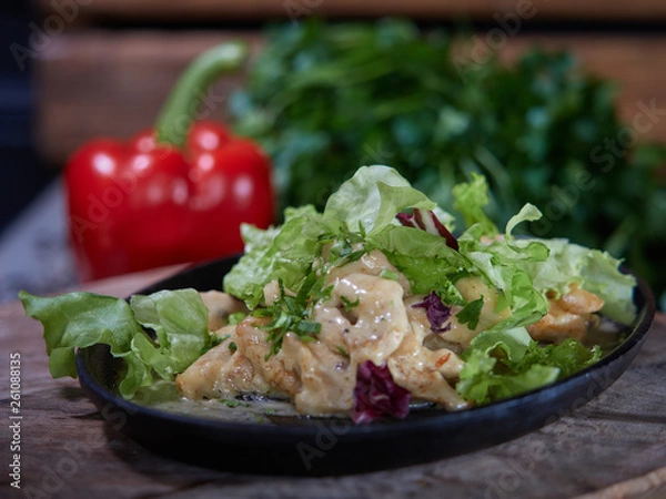 Fototapeta Portion of meat sprinkled with white sauce.