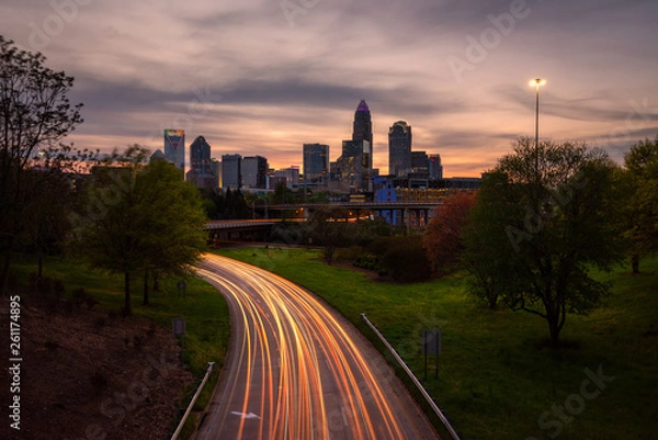 Obraz Car light trails at sunset with Charlotte city skyline in background