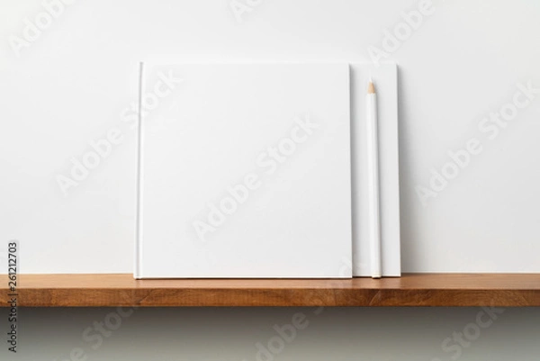 Fototapeta two white square notebook on bookshelf