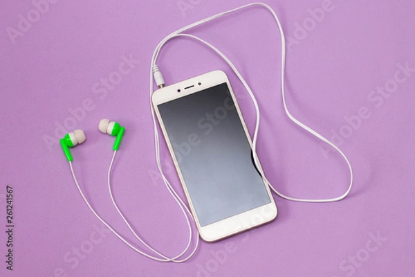 Obraz Headphones with a smartphone on a lilac background - listening to music, concept