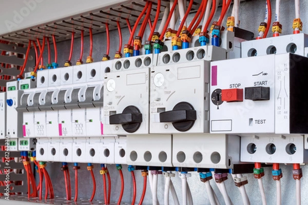 Fototapeta The electrical control panel are circuit breakers protecting the motor and relay. Circuit breakers with rotary handles and push-button and arranged in a row. Wires with ferrules number coded.