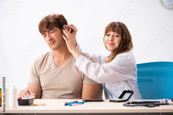 Fototapeta Patient with hearing problem visiting doctor otorhinolaryngologi